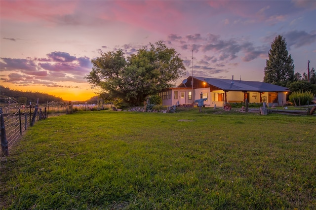 view of yard at dusk