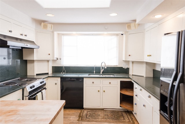 kitchen with dishwasher, electric range, sink, stainless steel refrigerator with ice dispenser, and white cabinetry