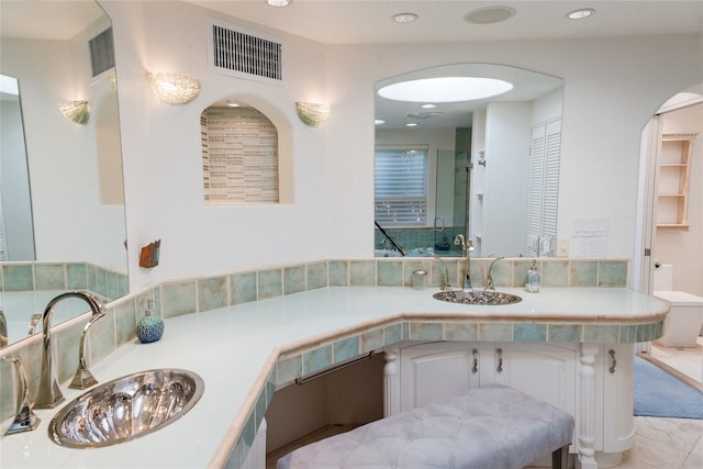 bathroom featuring tile patterned flooring, vanity, and toilet