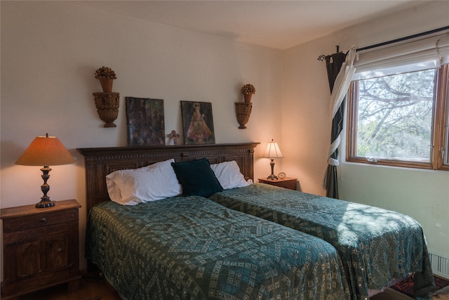 bedroom with hardwood / wood-style flooring