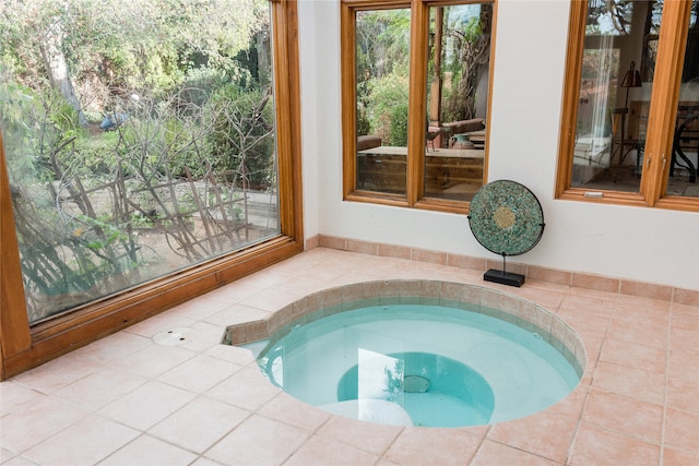 view of swimming pool featuring an in ground hot tub