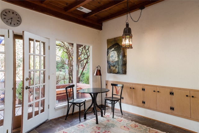 dining space with wood ceiling and beam ceiling