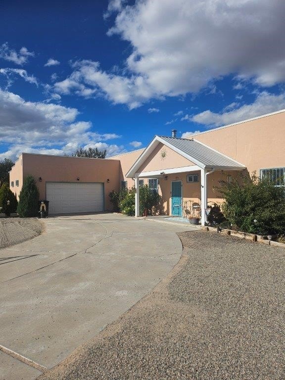 view of front of house with a garage and a carport