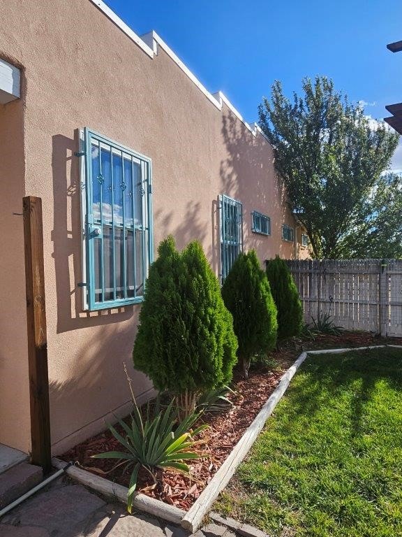 view of property exterior featuring a lawn