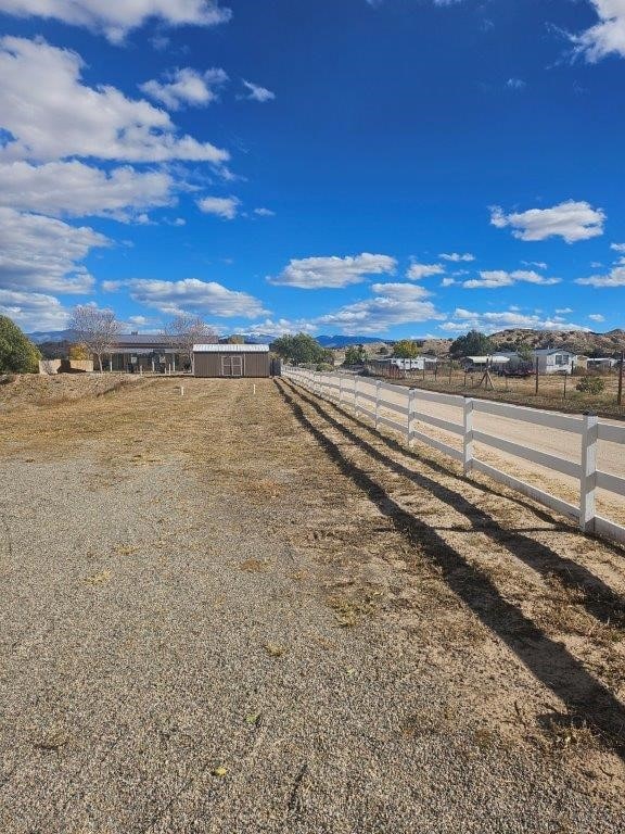 view of yard with a rural view