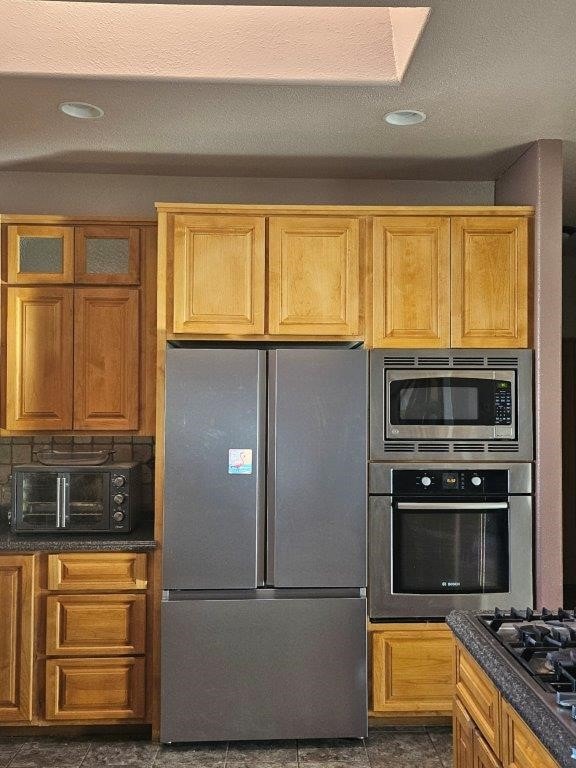 kitchen featuring appliances with stainless steel finishes and tasteful backsplash