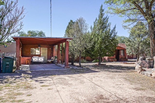 exterior space with ceiling fan