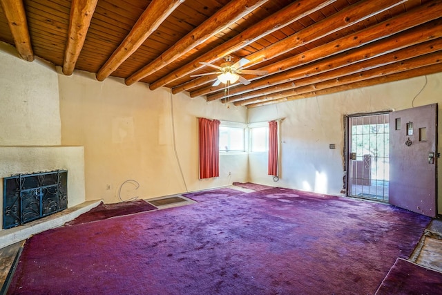 unfurnished living room with ceiling fan, carpet flooring, plenty of natural light, and beam ceiling