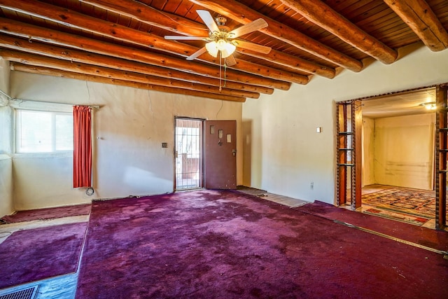 carpeted empty room with ceiling fan, beam ceiling, and wooden ceiling