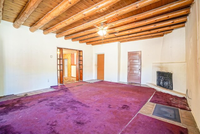 unfurnished living room with wooden ceiling, beam ceiling, and ceiling fan