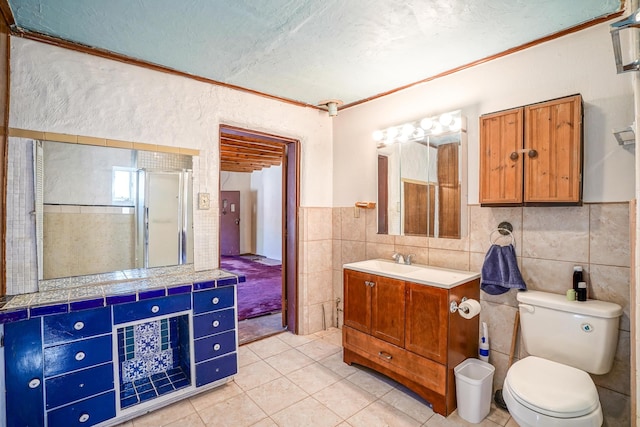 bathroom featuring vanity, tile patterned flooring, a textured ceiling, a shower with shower door, and toilet