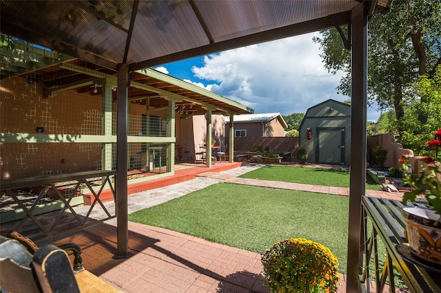 view of yard with a storage unit and a patio area