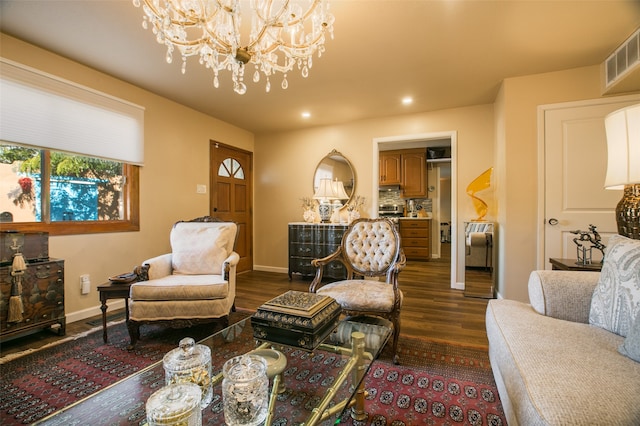 living room featuring a notable chandelier and dark hardwood / wood-style flooring