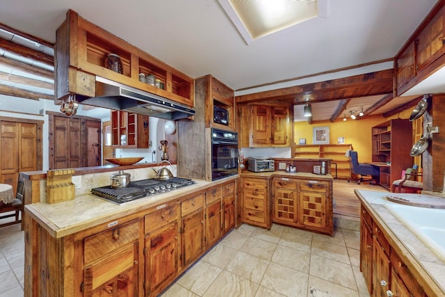 kitchen featuring light tile patterned flooring, stainless steel gas cooktop, beamed ceiling, black oven, and tile countertops