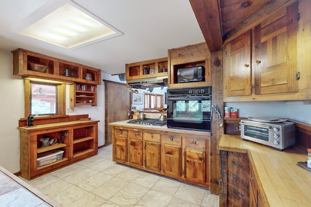 kitchen featuring light hardwood / wood-style floors, black appliances, and exhaust hood