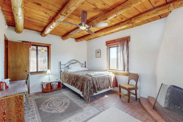 bedroom with ceiling fan, beam ceiling, and wooden ceiling