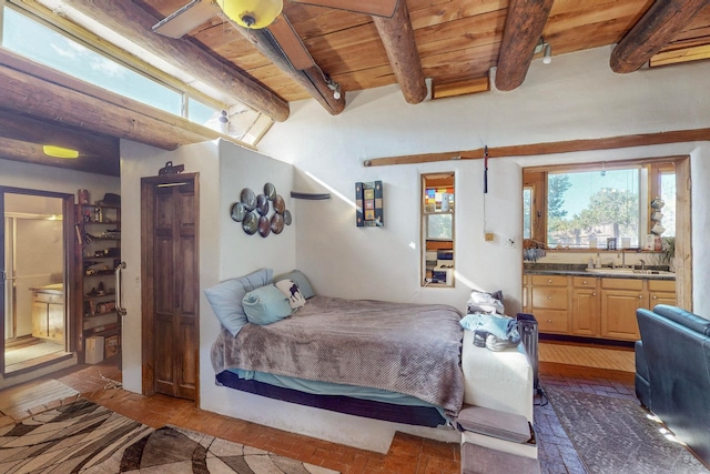 bedroom featuring light hardwood / wood-style floors, ensuite bathroom, wood ceiling, and beam ceiling