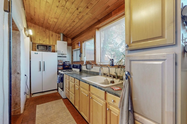 kitchen with light brown cabinets, wood ceiling, sink, white appliances, and wooden walls