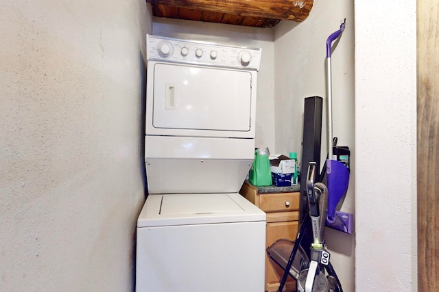 laundry room with stacked washer / drying machine