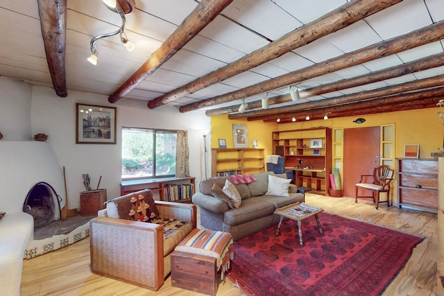 living room with beam ceiling and light hardwood / wood-style floors