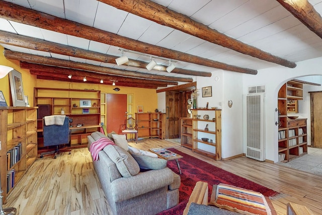 living room featuring light hardwood / wood-style flooring and beam ceiling