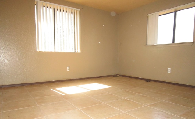 unfurnished room featuring light tile patterned flooring