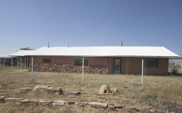 back of house with metal roof