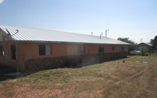 rear view of house with a lawn