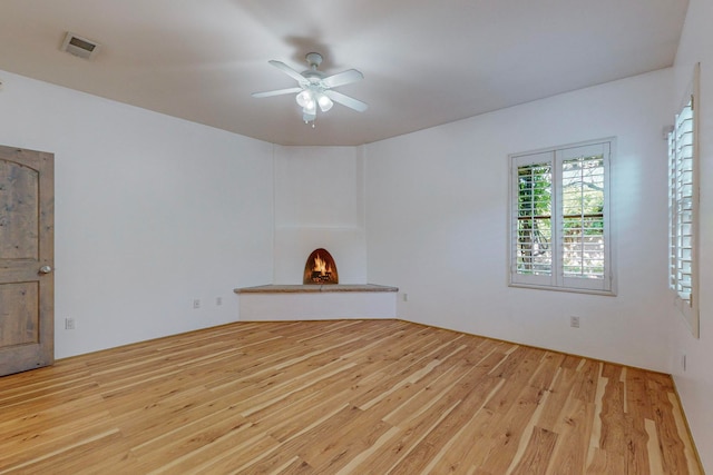 unfurnished room with light hardwood / wood-style floors and ceiling fan