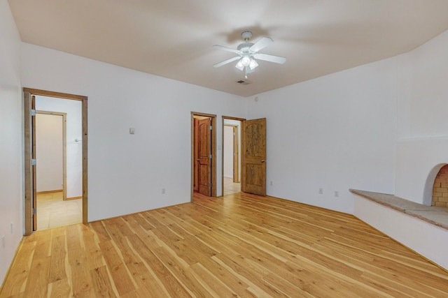 interior space with light hardwood / wood-style floors and ceiling fan