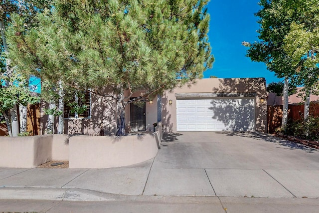 pueblo-style house with a garage