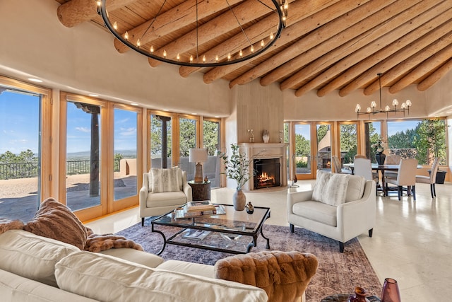 living room featuring beamed ceiling, wood ceiling, light tile patterned flooring, a chandelier, and a towering ceiling