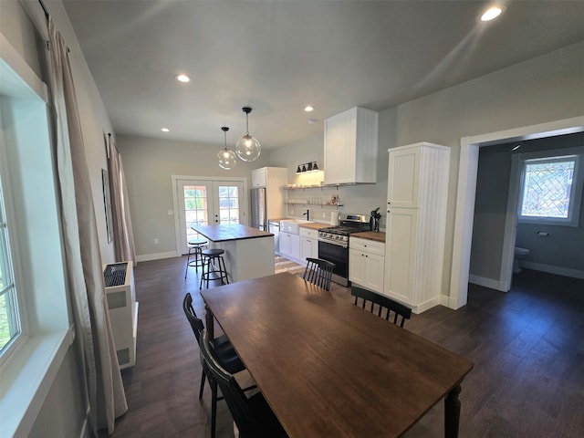 dining room featuring dark wood-type flooring, french doors, and sink