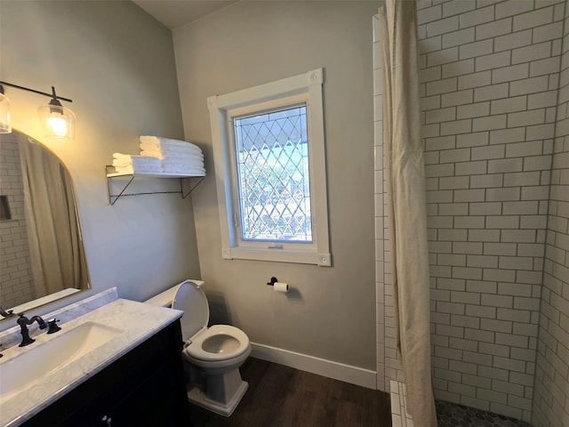 bathroom with curtained shower, hardwood / wood-style floors, vanity, and toilet