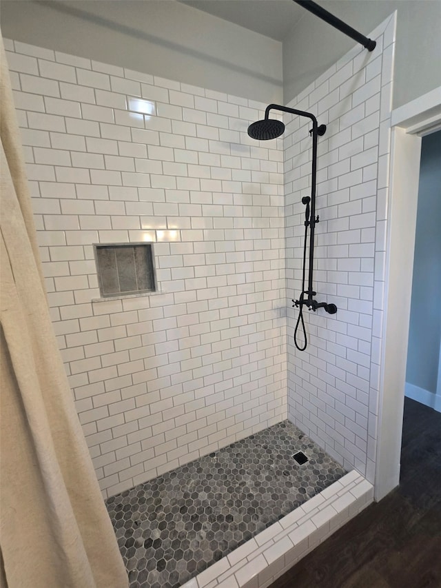 bathroom with a shower with shower curtain and hardwood / wood-style flooring