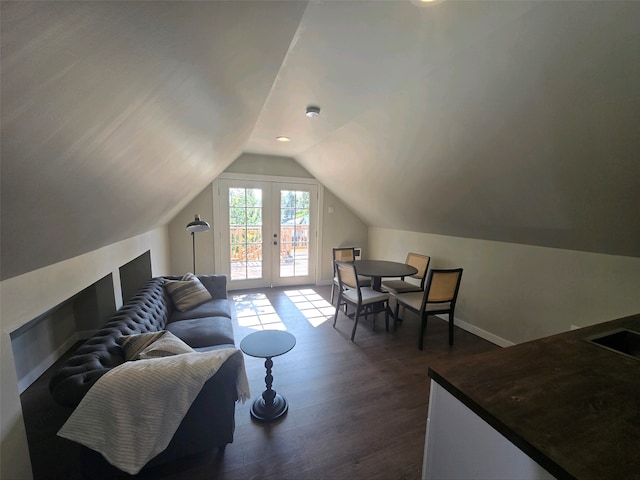 living room with lofted ceiling, french doors, and dark hardwood / wood-style floors