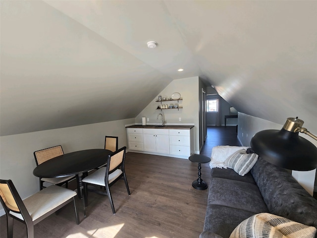 office area with vaulted ceiling, sink, and dark wood-type flooring