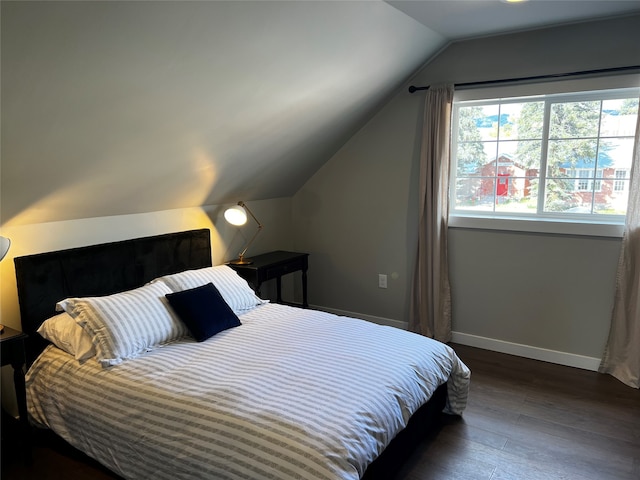 bedroom featuring vaulted ceiling and dark hardwood / wood-style flooring