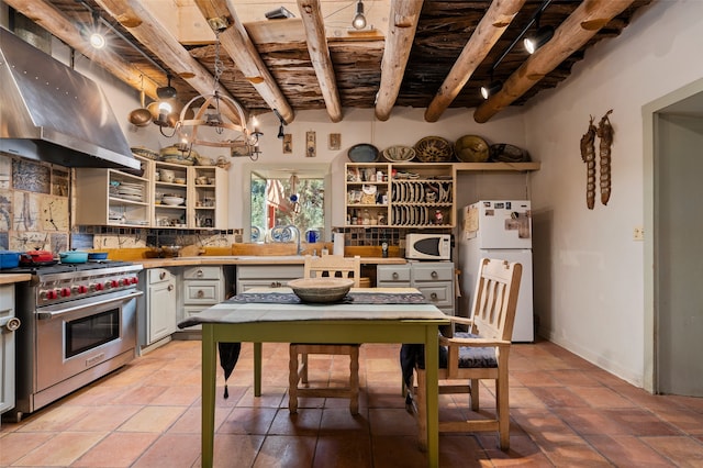 kitchen featuring beamed ceiling, decorative backsplash, white appliances, decorative light fixtures, and range hood