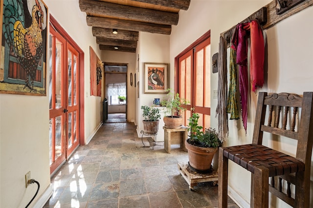 hall with french doors and beam ceiling