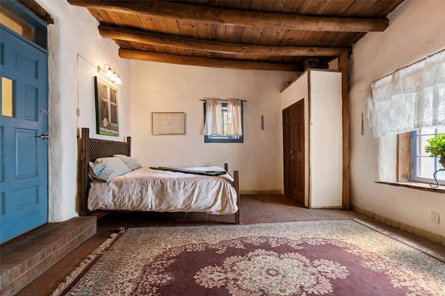 bedroom with hardwood / wood-style flooring, beam ceiling, and wooden ceiling