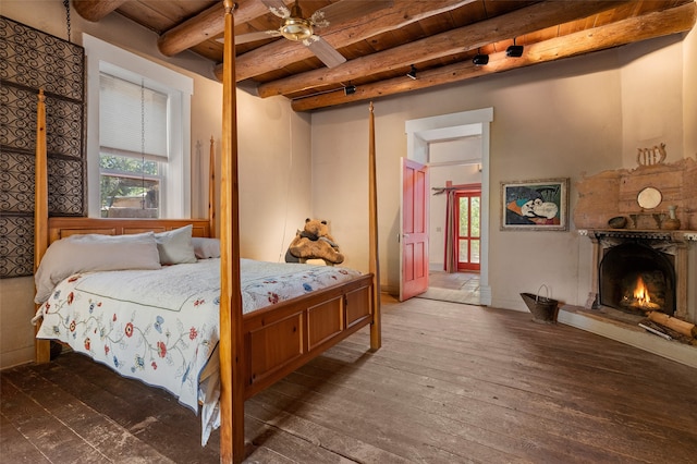 bedroom featuring beamed ceiling, wood ceiling, dark hardwood / wood-style flooring, and multiple windows