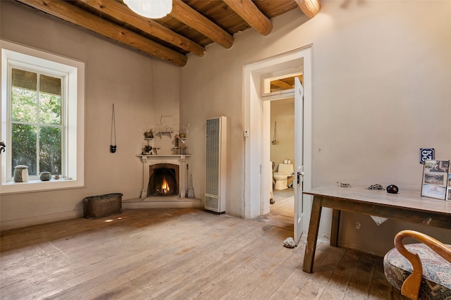 living room with wooden ceiling, beamed ceiling, and light hardwood / wood-style flooring