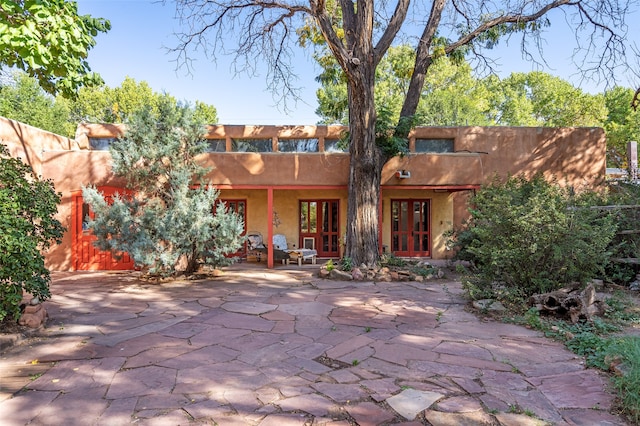 rear view of house with french doors and a patio area