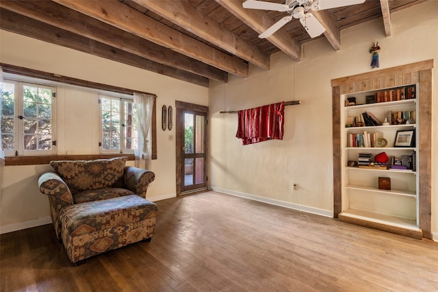 sitting room with wood-type flooring, wood ceiling, beam ceiling, and ceiling fan