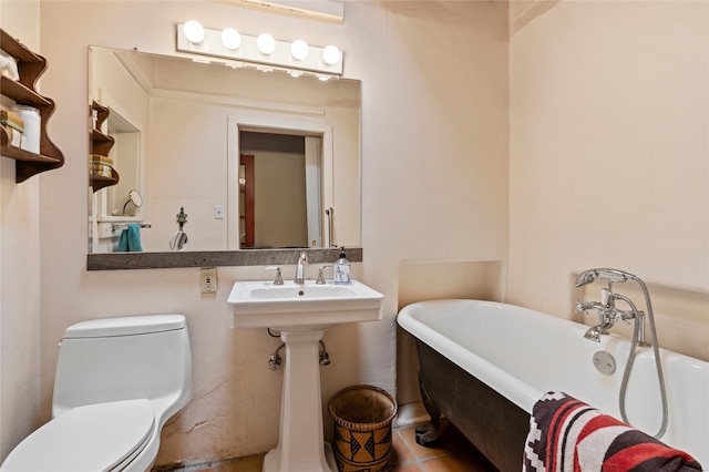 bathroom with tile patterned flooring, a bath, sink, and toilet