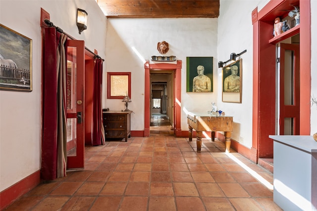 hall with a barn door and high vaulted ceiling