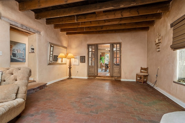 living room featuring a high ceiling and beam ceiling