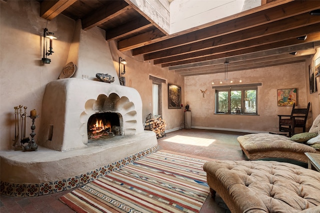 living room with beam ceiling and a large fireplace