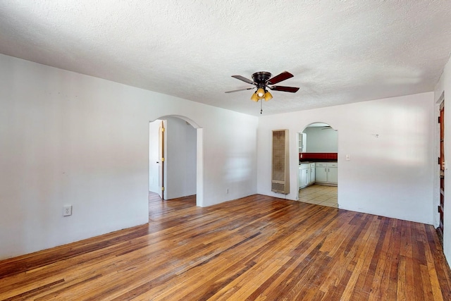 unfurnished room featuring ceiling fan, a textured ceiling, and light hardwood / wood-style floors